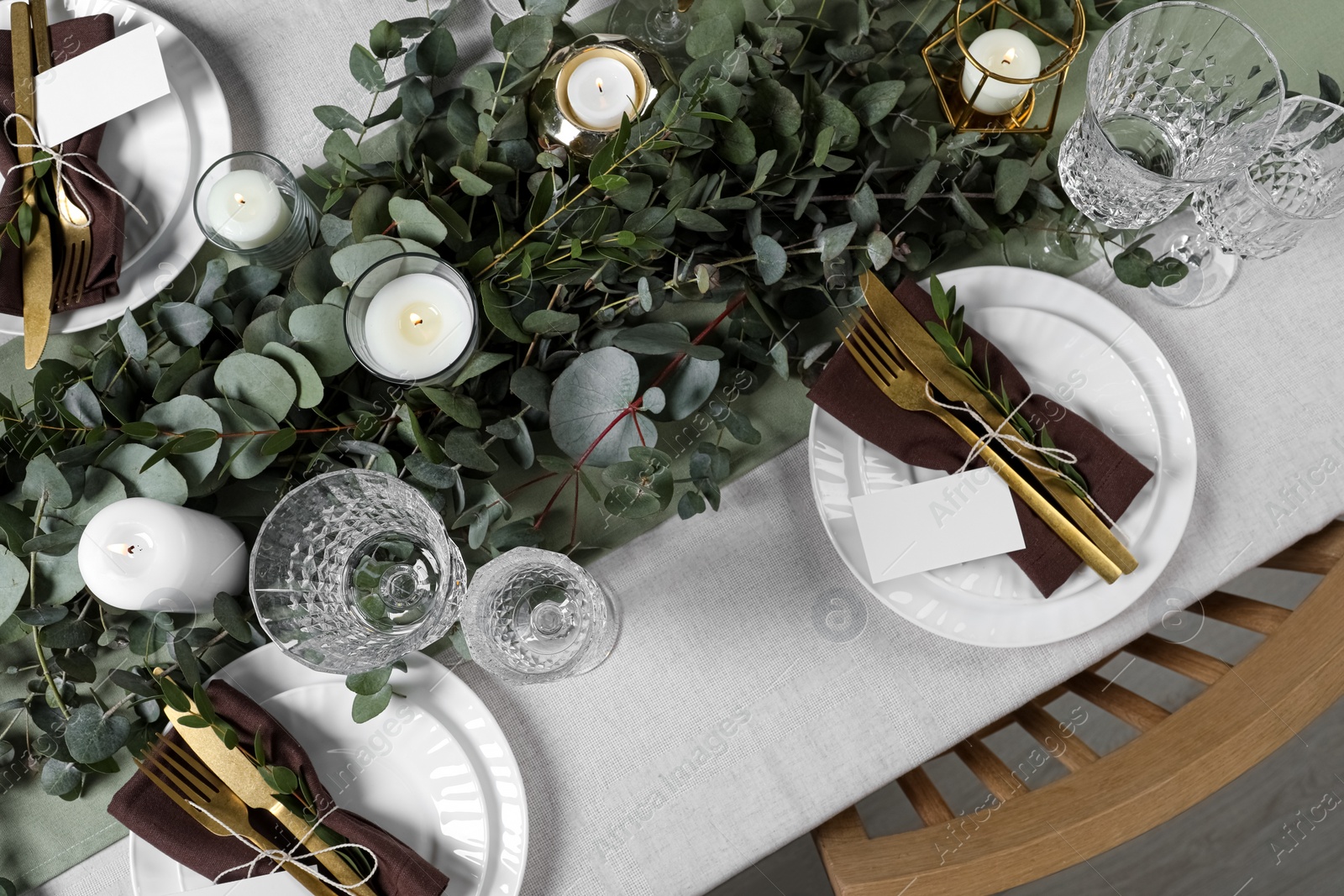 Luxury table setting with beautiful decor and blank cards. Festive dinner Photo of Luxury table setting with beautiful decor and blank cards. Festive dinner