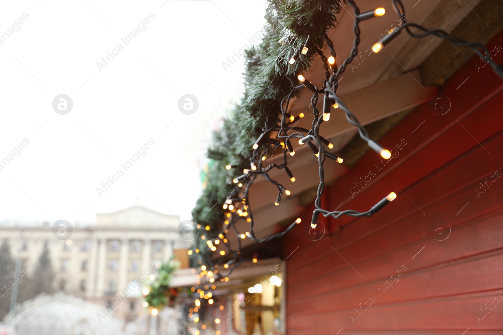 Christmas fair stall with string lights outdoors, closeup Photo of Christmas fair stall with string lights outdoors, closeup
