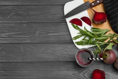 Fresh beet juice and raw vegetable on grey wooden table, flat lay. Space for text Photo of Fresh beet juice and raw vegetable on grey wooden table, flat lay. Space for text
