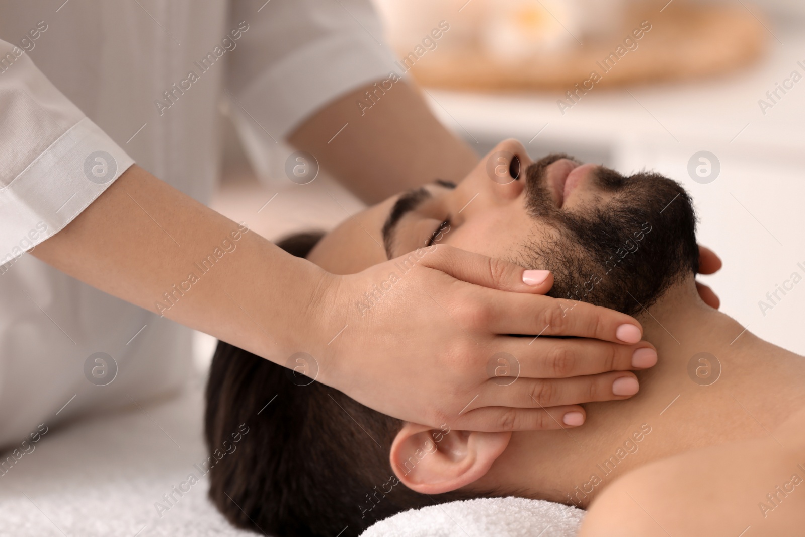 Young man receiving facial massage in beauty salon, closeup Photo of Young man receiving facial massage in beauty salon, closeup