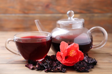 Composition with delicious hibiscus tea on wooden table Photo of Composition with delicious hibiscus tea on wooden table