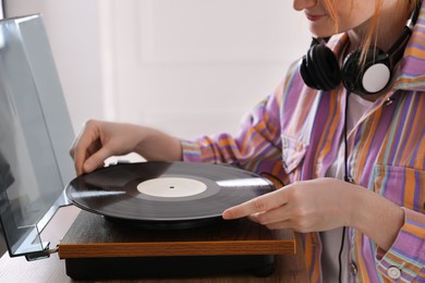 Young woman using turntable at home, closeup Photo of Young woman using turntable at home, closeup