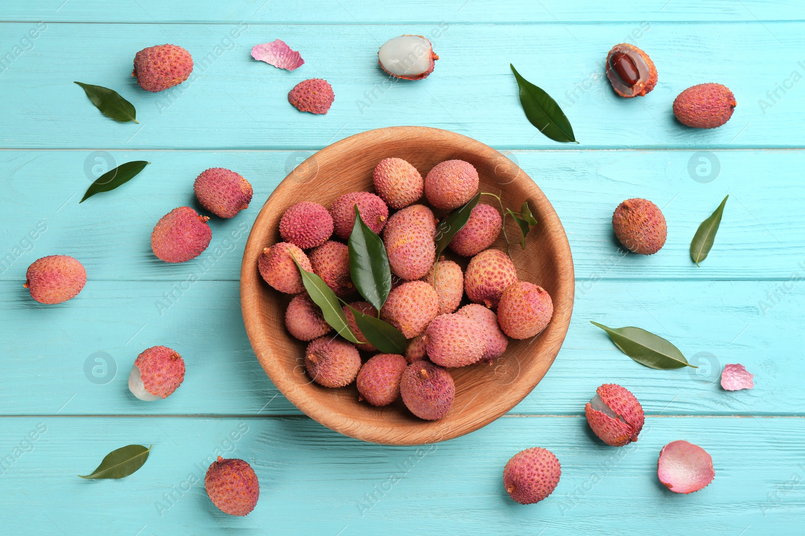Photo of Fresh ripe lychee fruits on light blue wooden table, flat lay