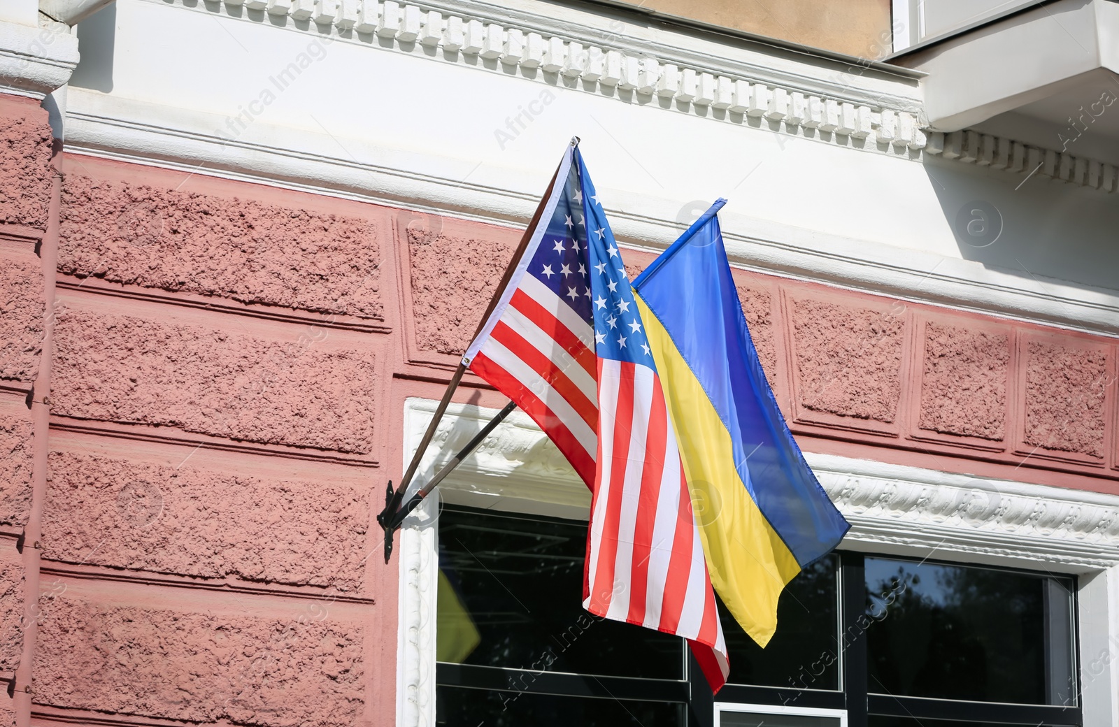 Flags of Ukraine and USA on building facade Photo of Flags of Ukraine and USA on building facade