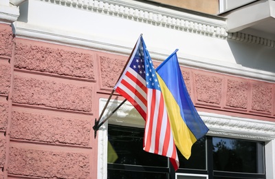 Flags of Ukraine and USA on building facade Photo of Flags of Ukraine and USA on building facade