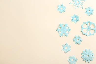 Many paper snowflakes on light background, flat lay. Space for text Photo of Many paper snowflakes on light background, flat lay. Space for text