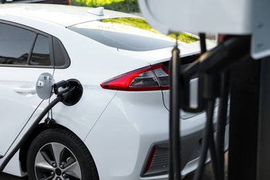 Charging modern electric car from station outdoors Photo of Charging modern electric car from station outdoors