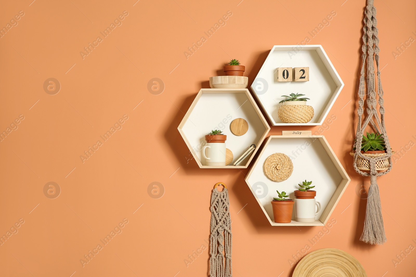 Photo of Shelves with decorative elements on color wall. Space for text