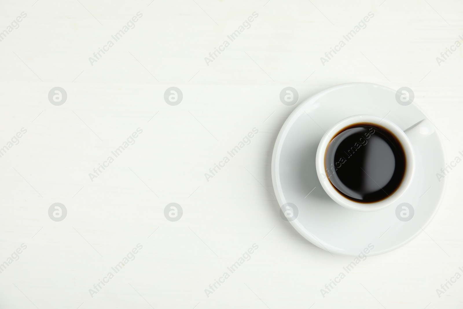 Cup of hot aromatic espresso on white background, top view Photo of Cup of hot aromatic espresso on white background, top view