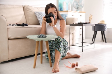 Young photographer taking picture of jewelry indoors Photo of Young photographer taking picture of jewelry indoors