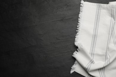 Striped kitchen towel on black table, top view. Space for text Photo of Striped kitchen towel on black table, top view. Space for text