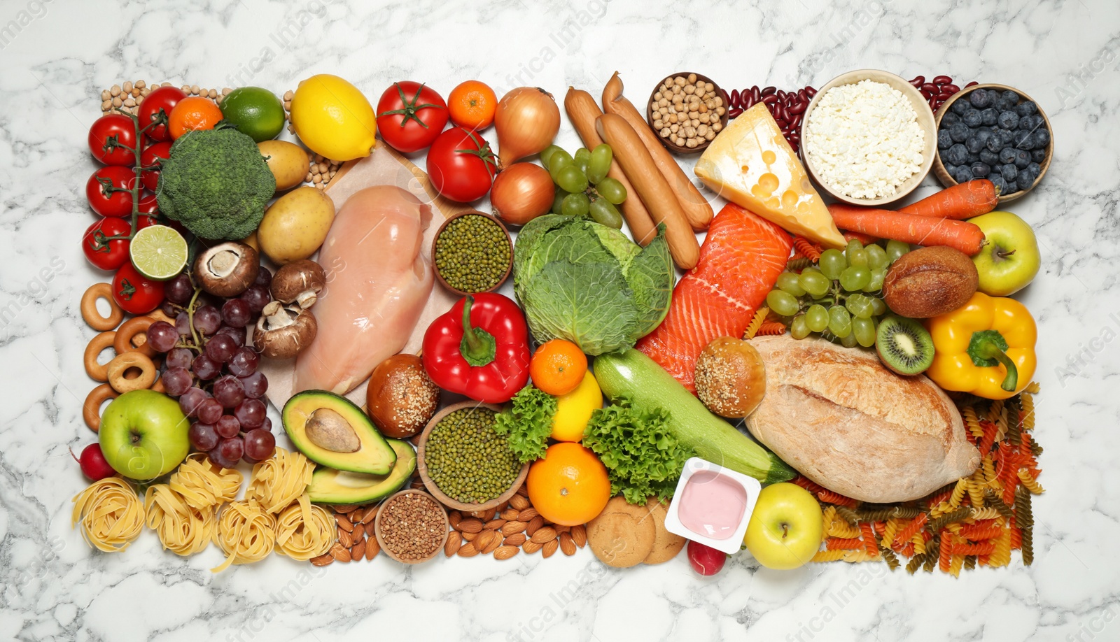 Different products on white marble table, top view. Healthy food and balanced diet Photo of Different products on white marble table, top view. Healthy food and balanced diet