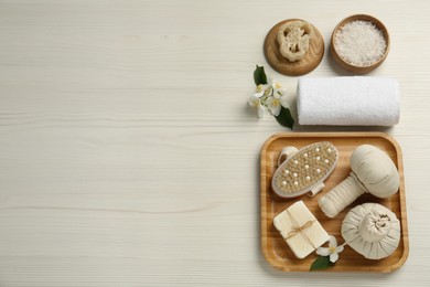 Flat lay composition with beautiful jasmine flowers and herbal bags on white wooden table, space for text Photo of Flat lay composition with beautiful jasmine flowers and herbal bags on white wooden table, space for text