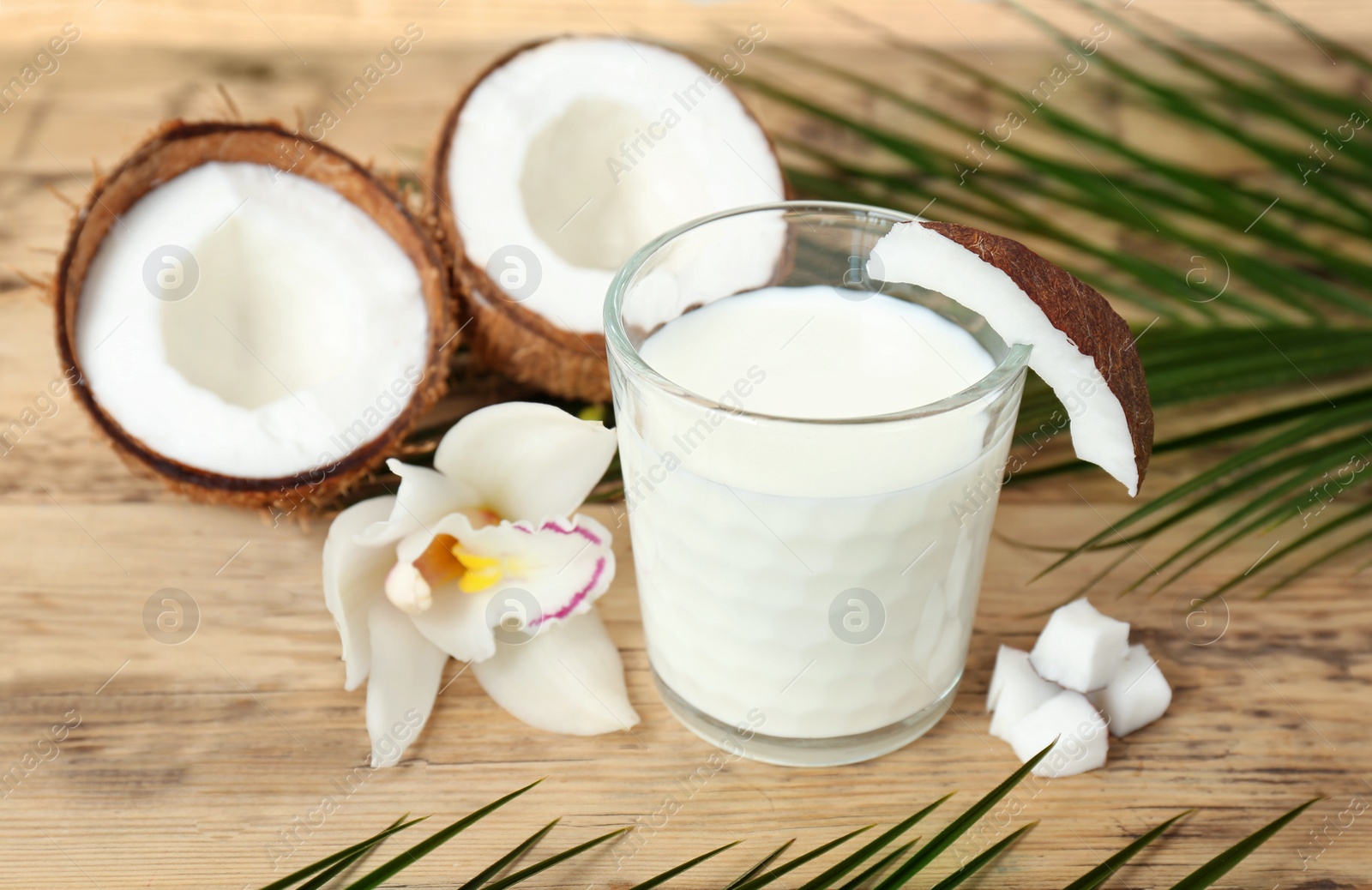 Glass of coconut milk on wooden background Photo of Glass of coconut milk on wooden background