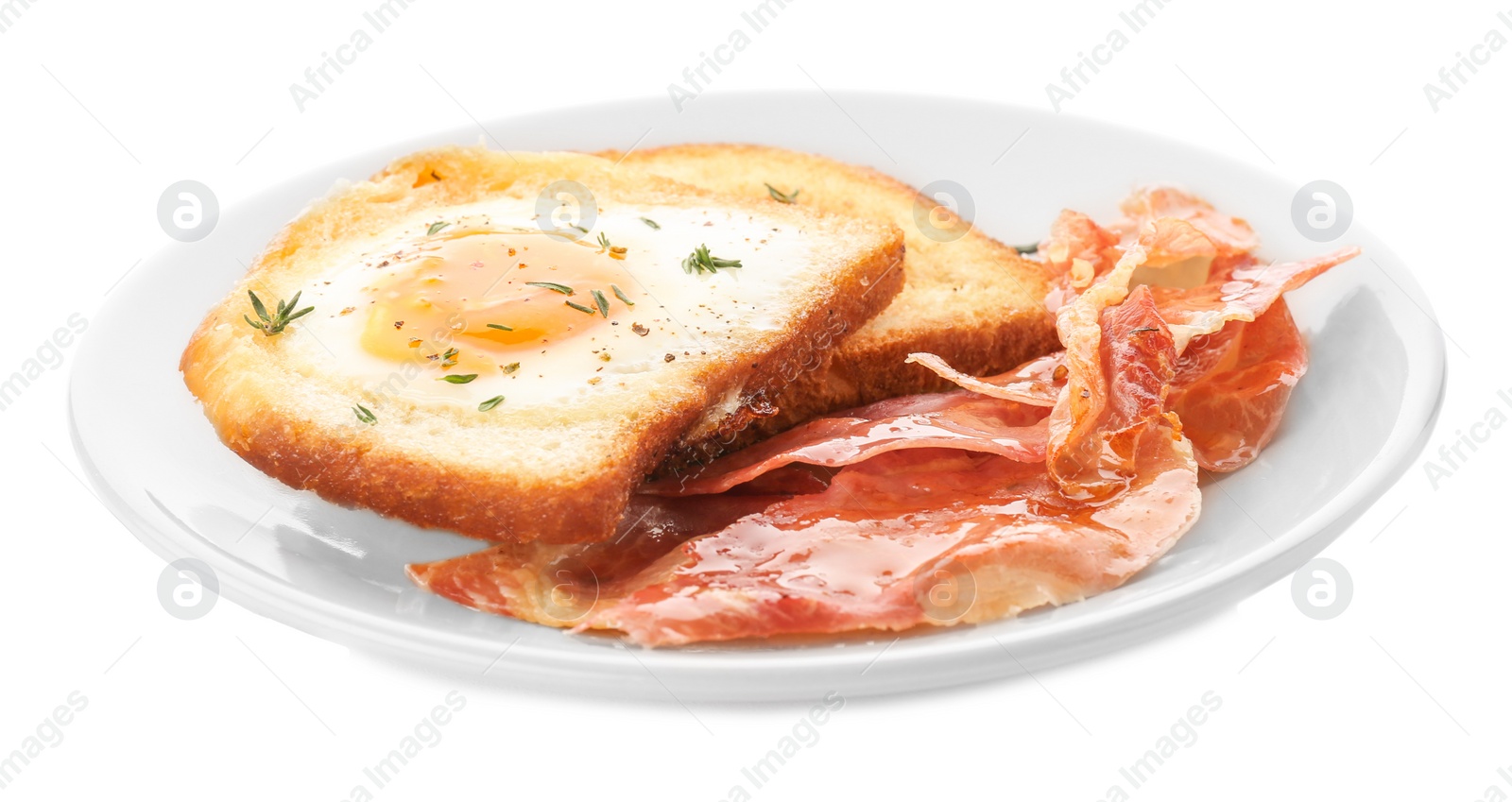 Plate with fried egg, bacon and toasts on white background Photo of Plate with fried egg, bacon and toasts on white background