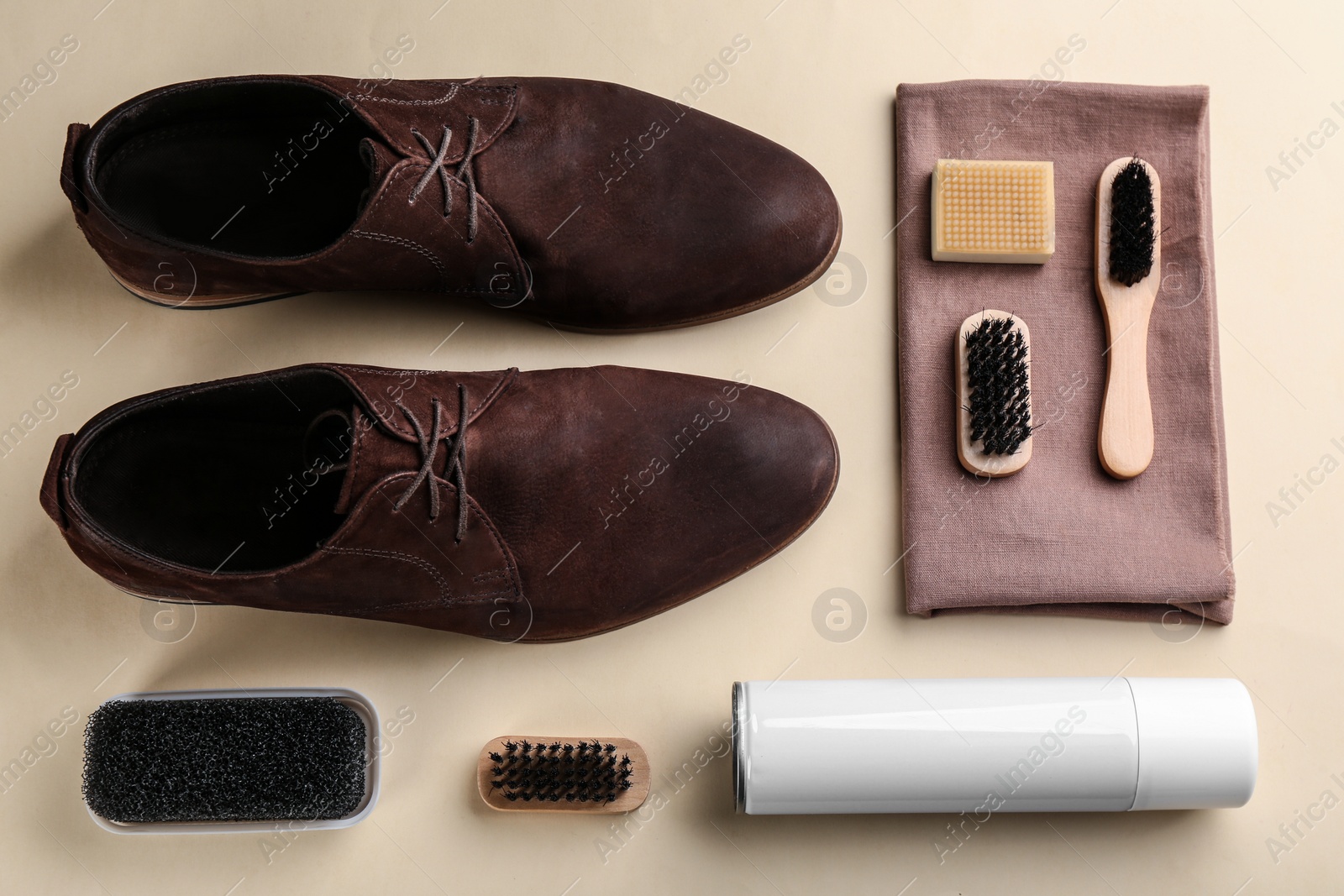 Stylish footwear with shoe care accessories on beige background, flat lay Photo of Stylish footwear with shoe care accessories on beige background, flat lay