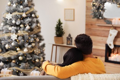 Couple in living room decorated for Christmas Image of Couple in living room decorated for Christmas