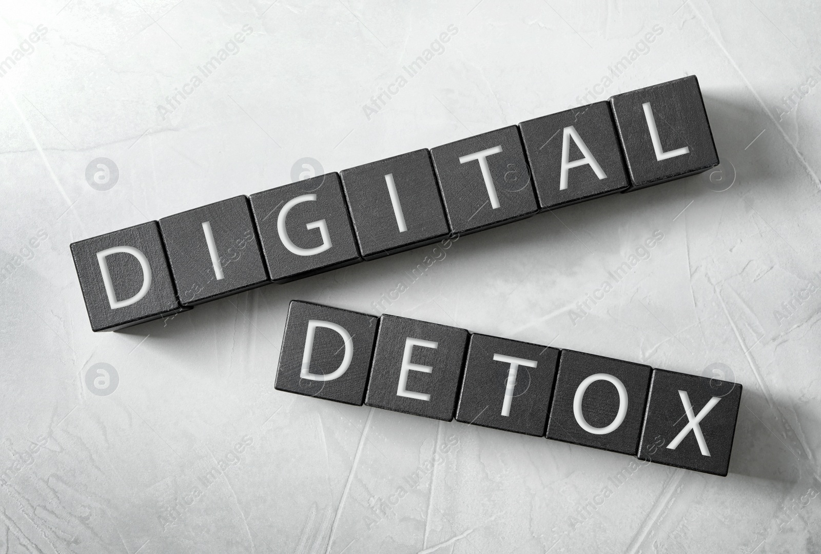 Black cubes with words DIGITAL DETOX on white background, flat lay Photo of Black cubes with words DIGITAL DETOX on white background, flat lay