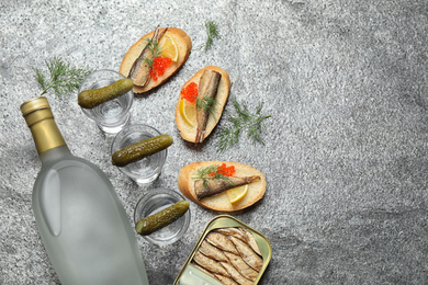 Flat lay composition with cold Russian vodka on grey table. Space for text Photo of Flat lay composition with cold Russian vodka on grey table. Space for text