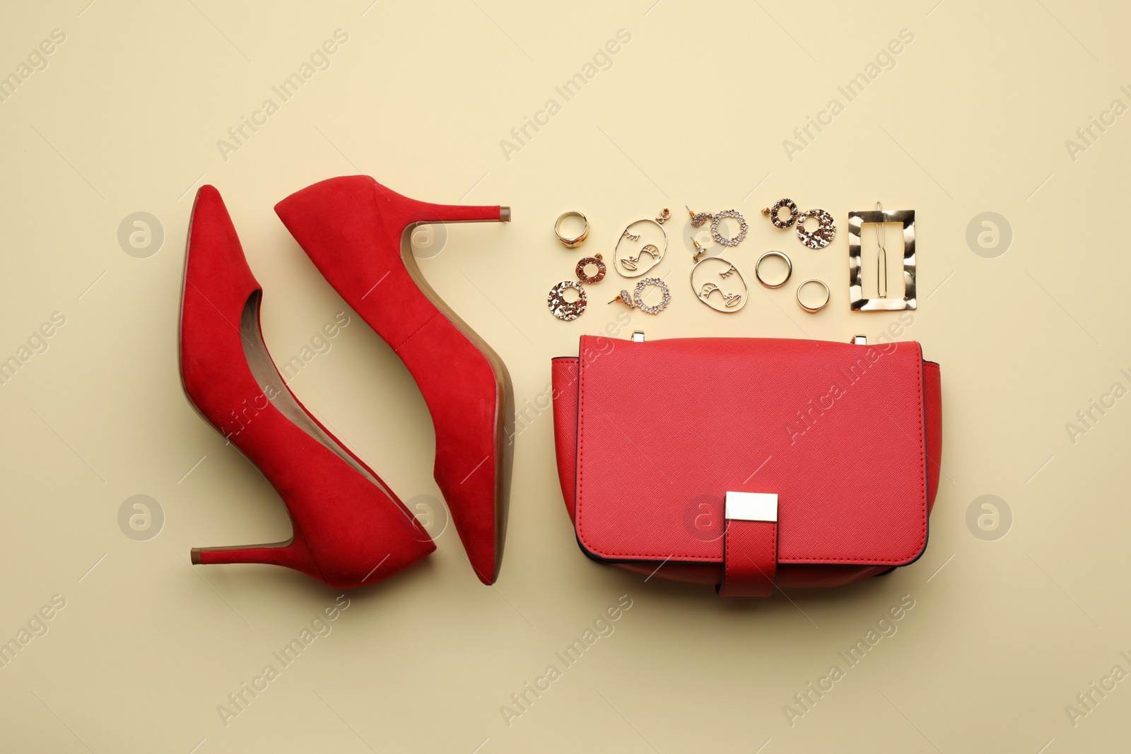 Stylish woman's bag, shoes and bijouterie on beige background, flat lay Photo of Stylish woman's bag, shoes and bijouterie on beige background, flat lay