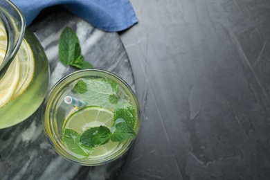 Delicious lemonade made with soda water and fresh mint on grey table, flat lay. Space for text Photo of Delicious lemonade made with soda water and fresh mint on grey table, flat lay. Space for text