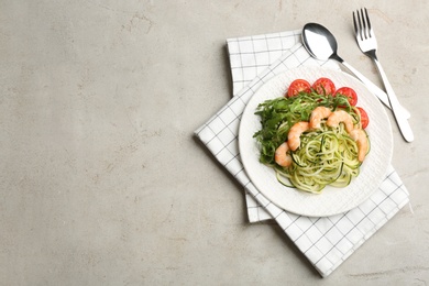 Delicious zucchini pasta with shrimps, cherry tomatoes and arugula served on light table, flat lay. Space for text Photo of Delicious zucchini pasta with shrimps, cherry tomatoes and arugula served on light table, flat lay. Space for text