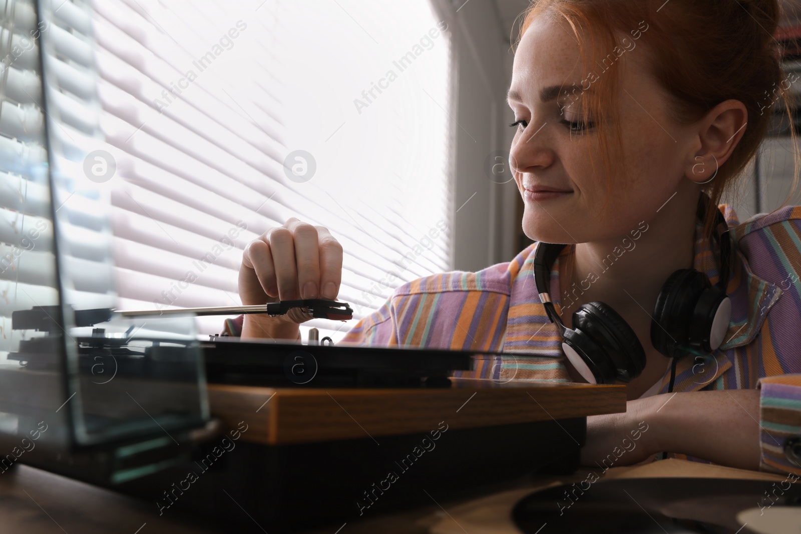 Young woman using turntable at home, closeup Photo of Young woman using turntable at home, closeup