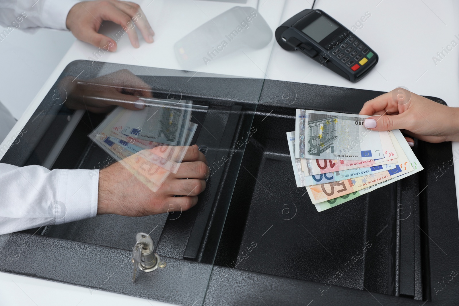 Woman with money at cash department window, closeup. Currency exchange Photo of Woman with money at cash department window, closeup. Currency exchange