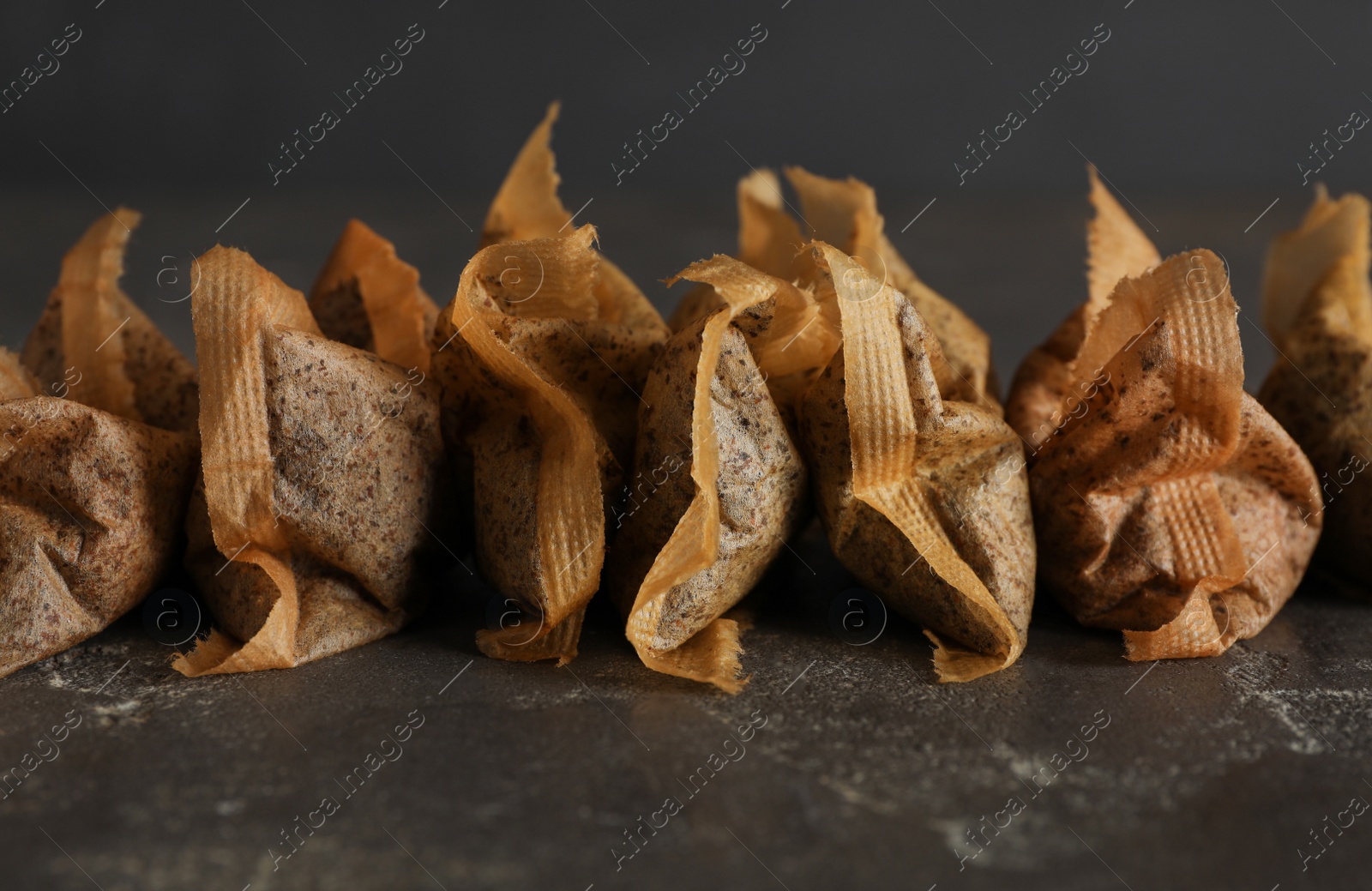 Many used tea bags on black table, closeup Photo of Many used tea bags on black table, closeup