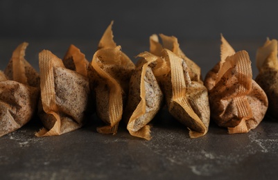 Many used tea bags on black table, closeup Photo of Many used tea bags on black table, closeup