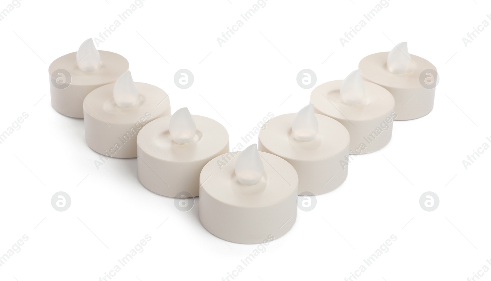 Decorative flameless LED candles on white background Photo of Decorative flameless LED candles on white background