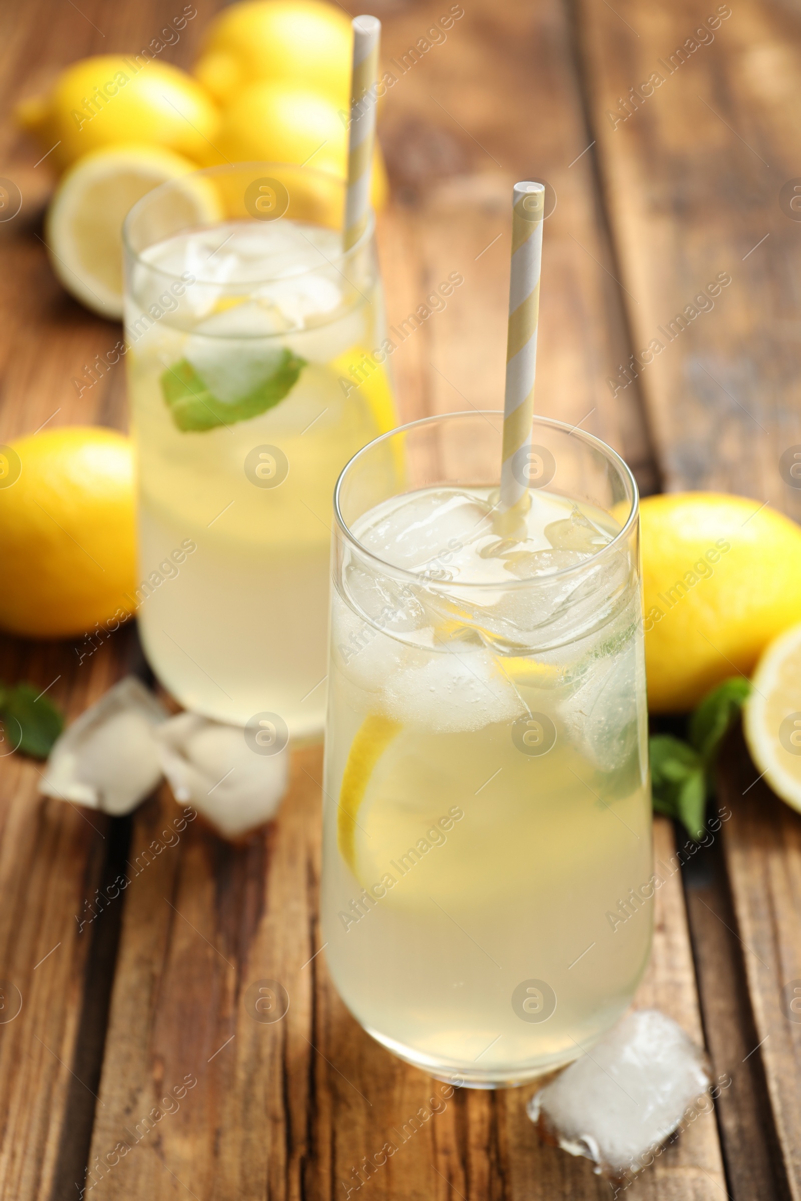 Natural lemonade with mint on wooden table. Summer refreshing drink Photo of Natural lemonade with mint on wooden table. Summer refreshing drink