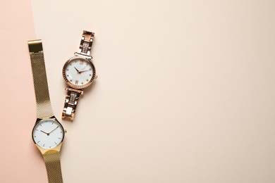 Photo of Luxury wrist watches on color background, flat lay. Space for text