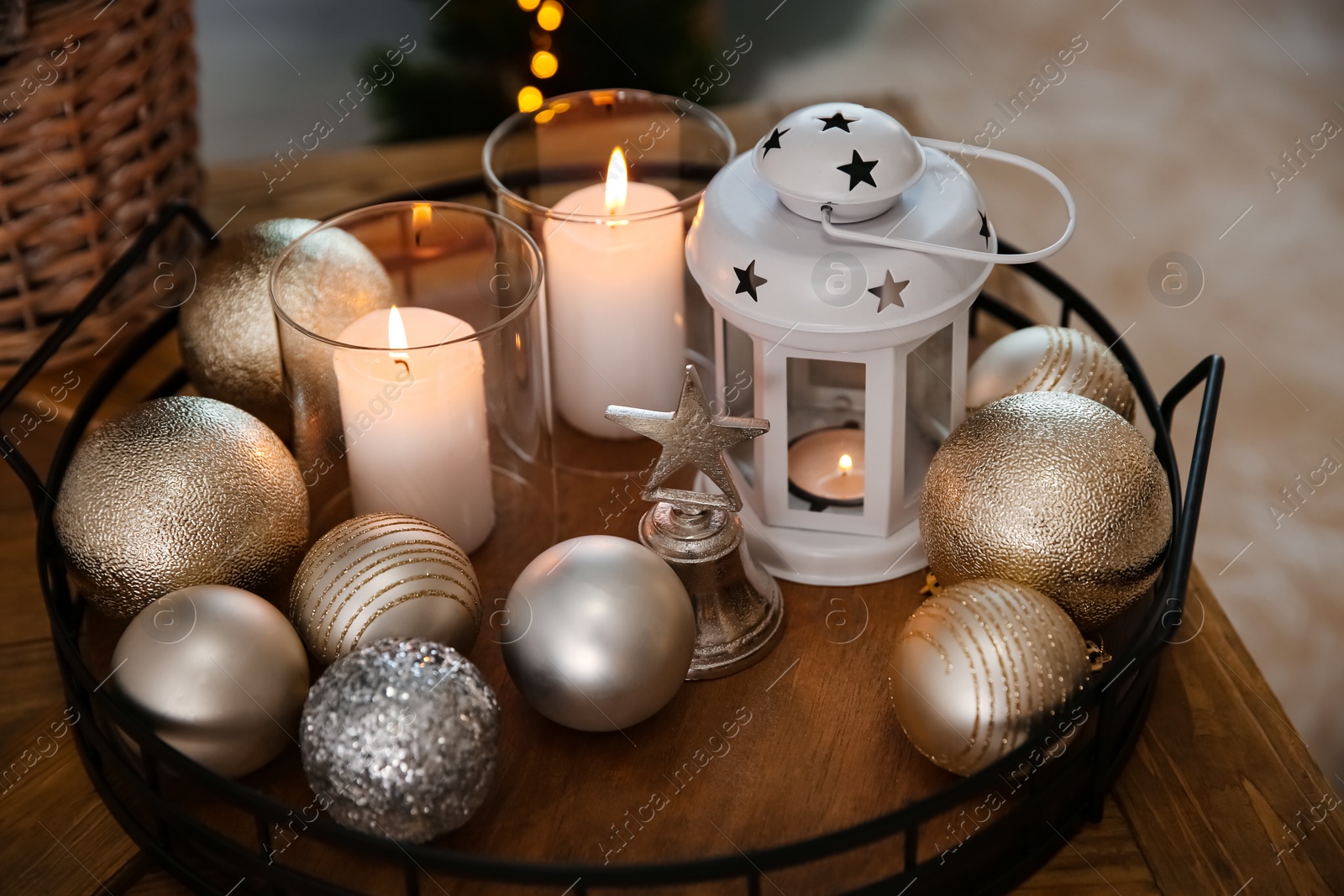 Burning candles, lantern and Christmas balls on wooden table indoors, closeup Photo of Burning candles, lantern and Christmas balls on wooden table indoors, closeup
