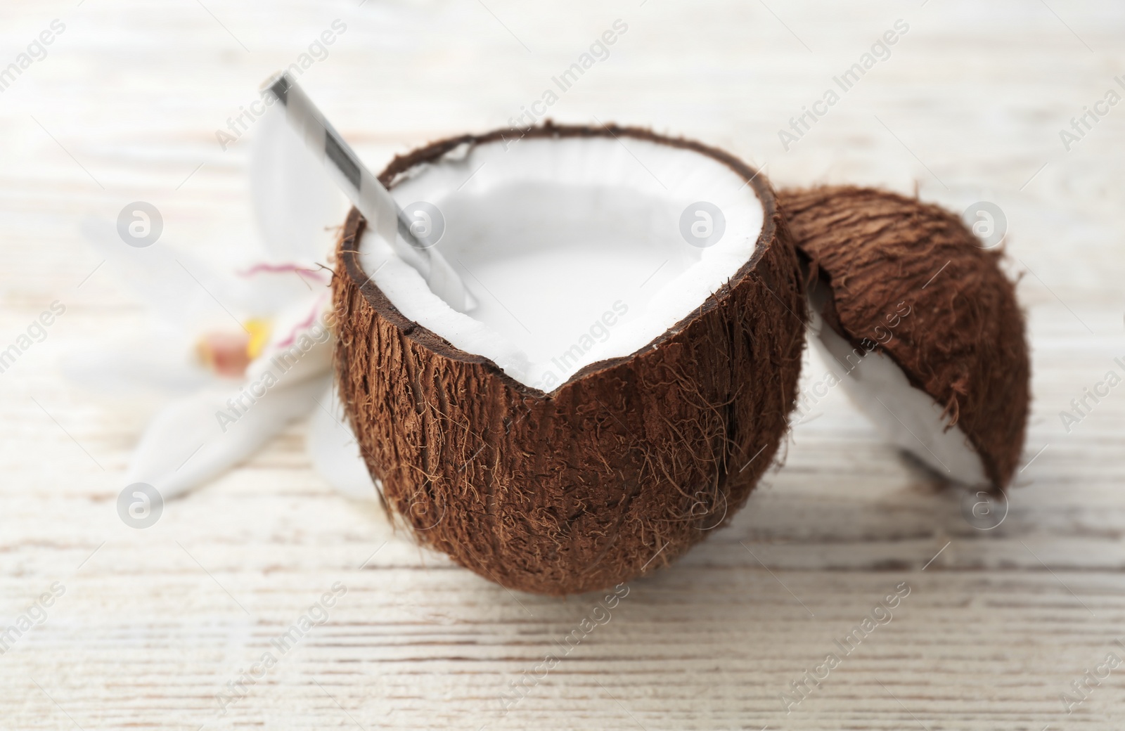 Nut with fresh coconut milk on wooden background Photo of Nut with fresh coconut milk on wooden background