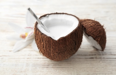 Nut with fresh coconut milk on wooden background Photo of Nut with fresh coconut milk on wooden background