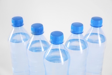 Plastic bottles with pure water on white background, closeup Photo of Plastic bottles with pure water on white background, closeup