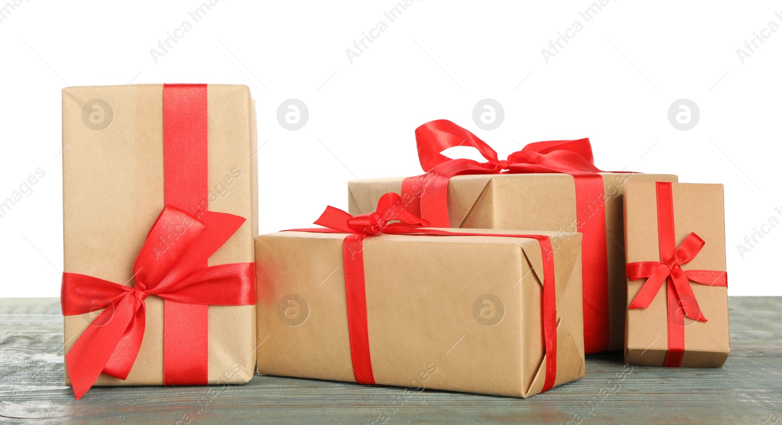 Many Christmas gifts on wooden table against white background Photo of Many Christmas gifts on wooden table against white background