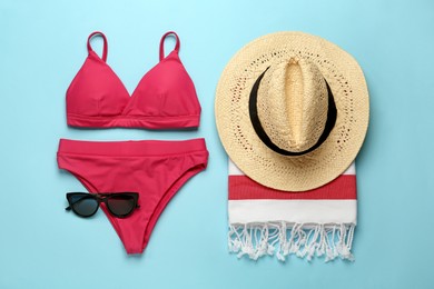 Flat lay composition with different beach objects on light blue background Photo of Flat lay composition with different beach objects on light blue background