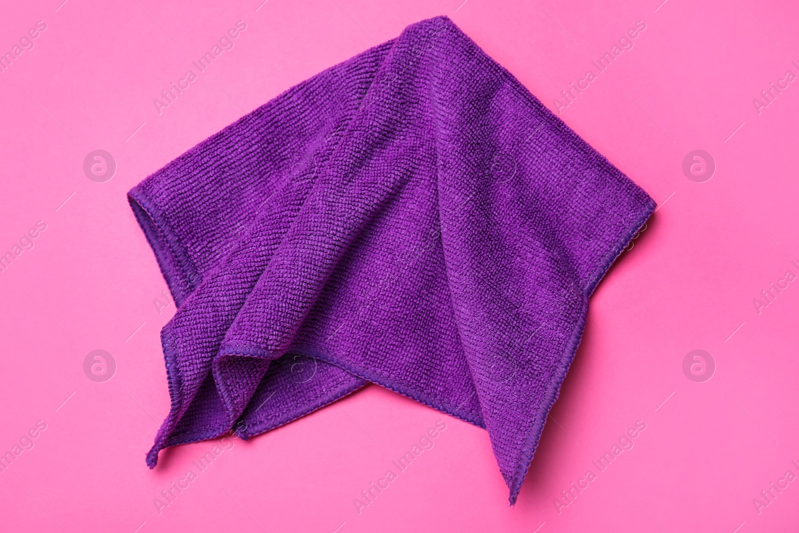 Purple microfiber cloth on pink background, top view Photo of Purple microfiber cloth on pink background, top view