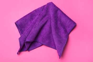 Purple microfiber cloth on pink background, top view Photo of Purple microfiber cloth on pink background, top view