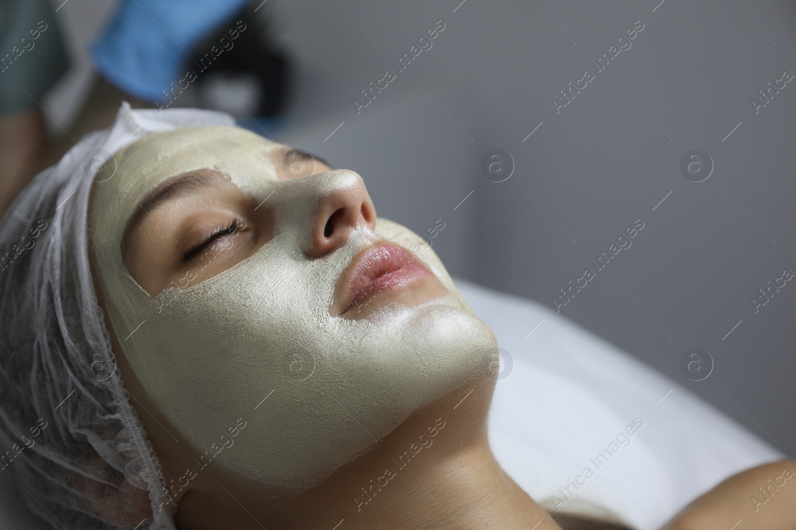 Beautiful woman with mask on her face in spa salon Photo of Beautiful woman with mask on her face in spa salon