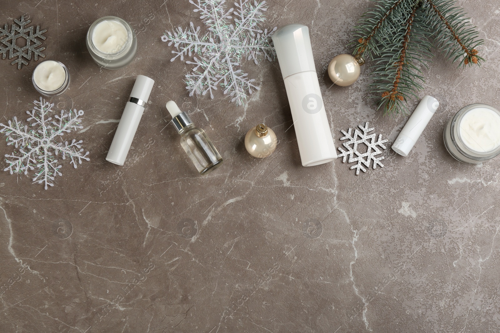 Flat lay composition with different cosmetic products on grey table, space for text. Winter care Photo of Flat lay composition with different cosmetic products on grey table, space for text. Winter care