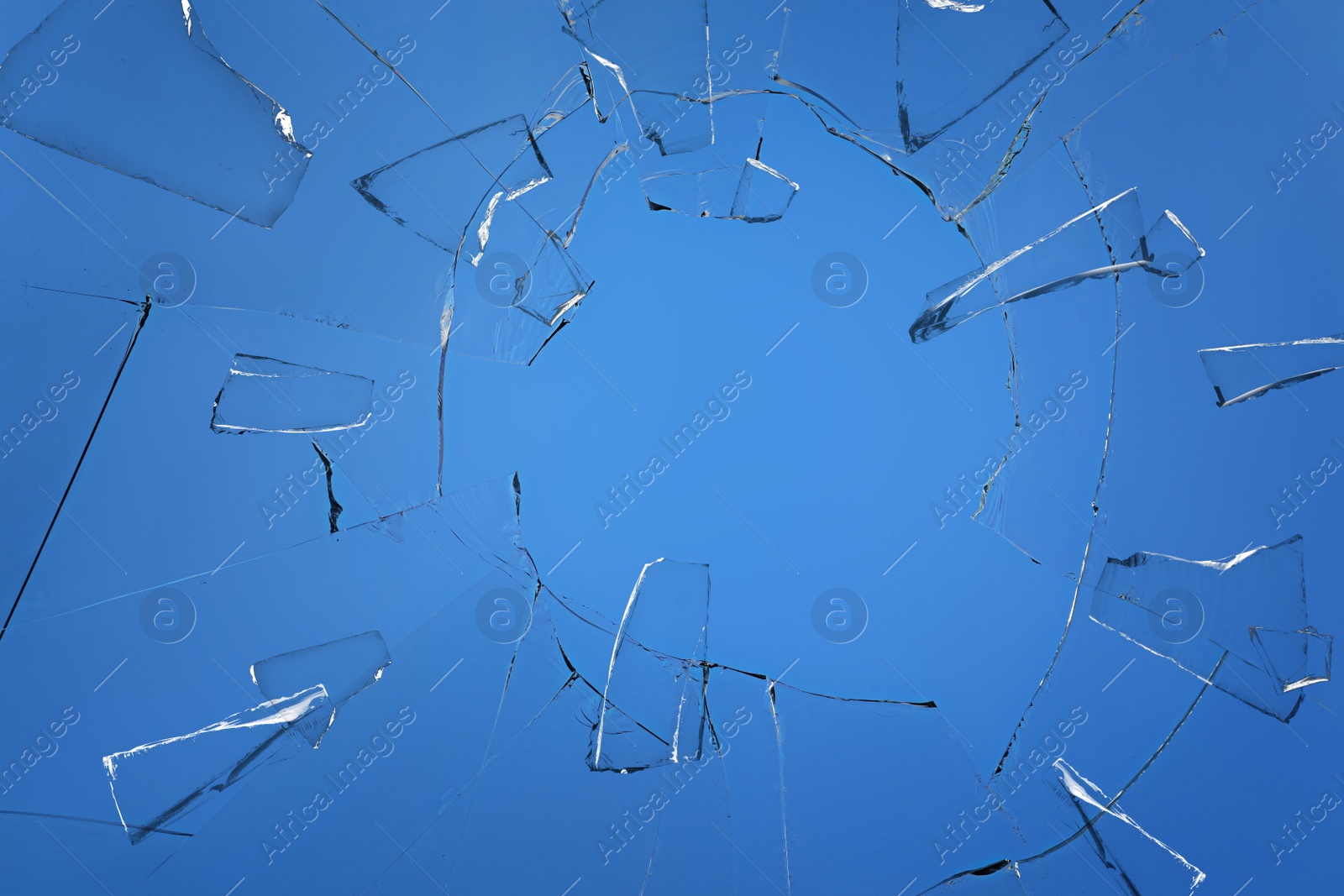 Broken glass with cracks on blue background Image of Broken glass with cracks on blue background