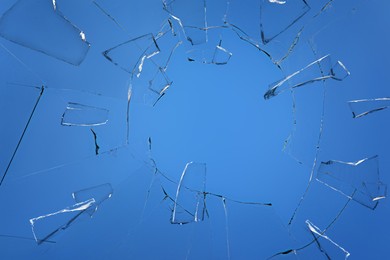 Broken glass with cracks on blue background Image of Broken glass with cracks on blue background