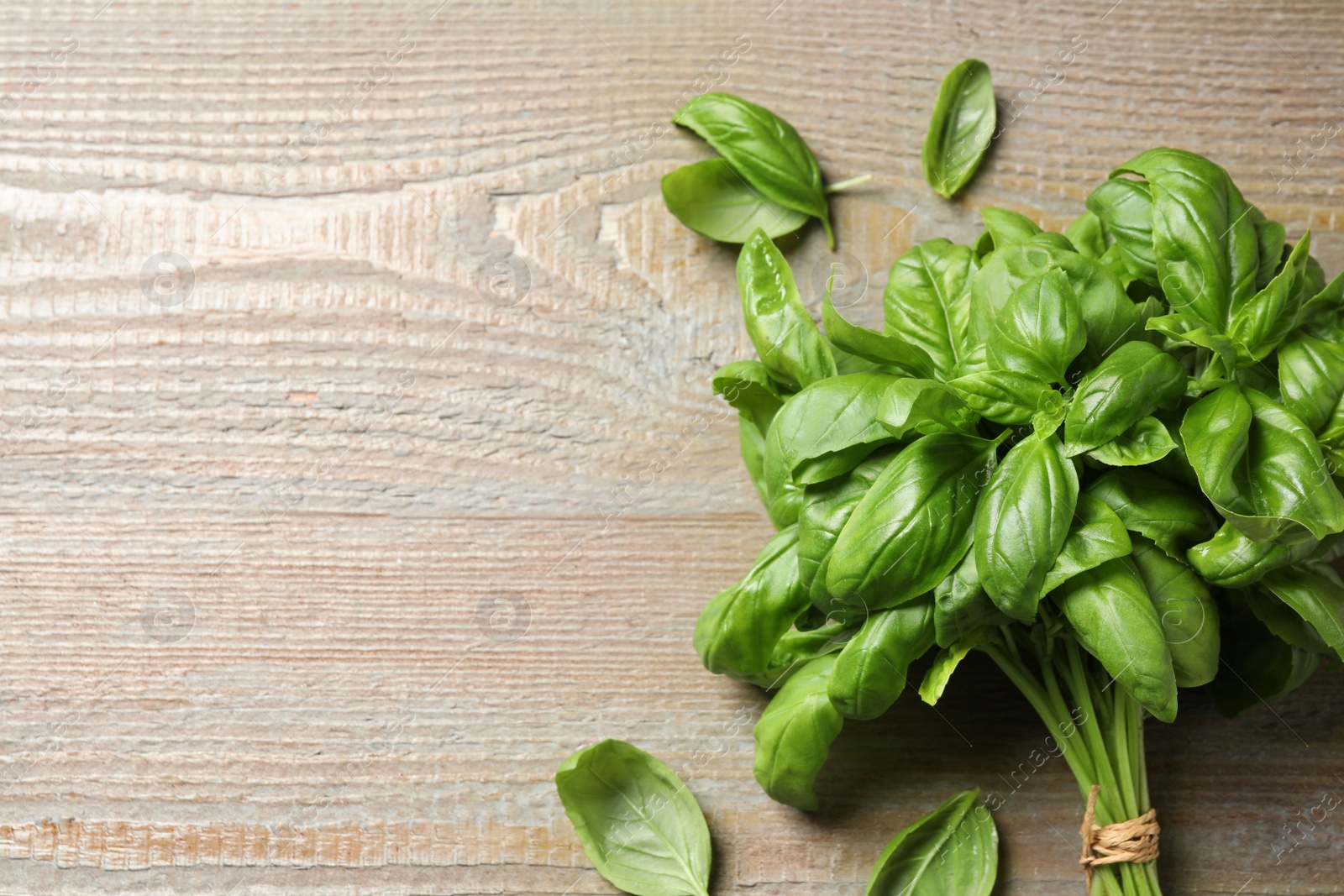 Fresh basil on wooden table, flat lay. Space for text Photo of Fresh basil on wooden table, flat lay. Space for text