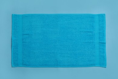 Soft beach towel on light blue background, top view Photo of Soft beach towel on light blue background, top view