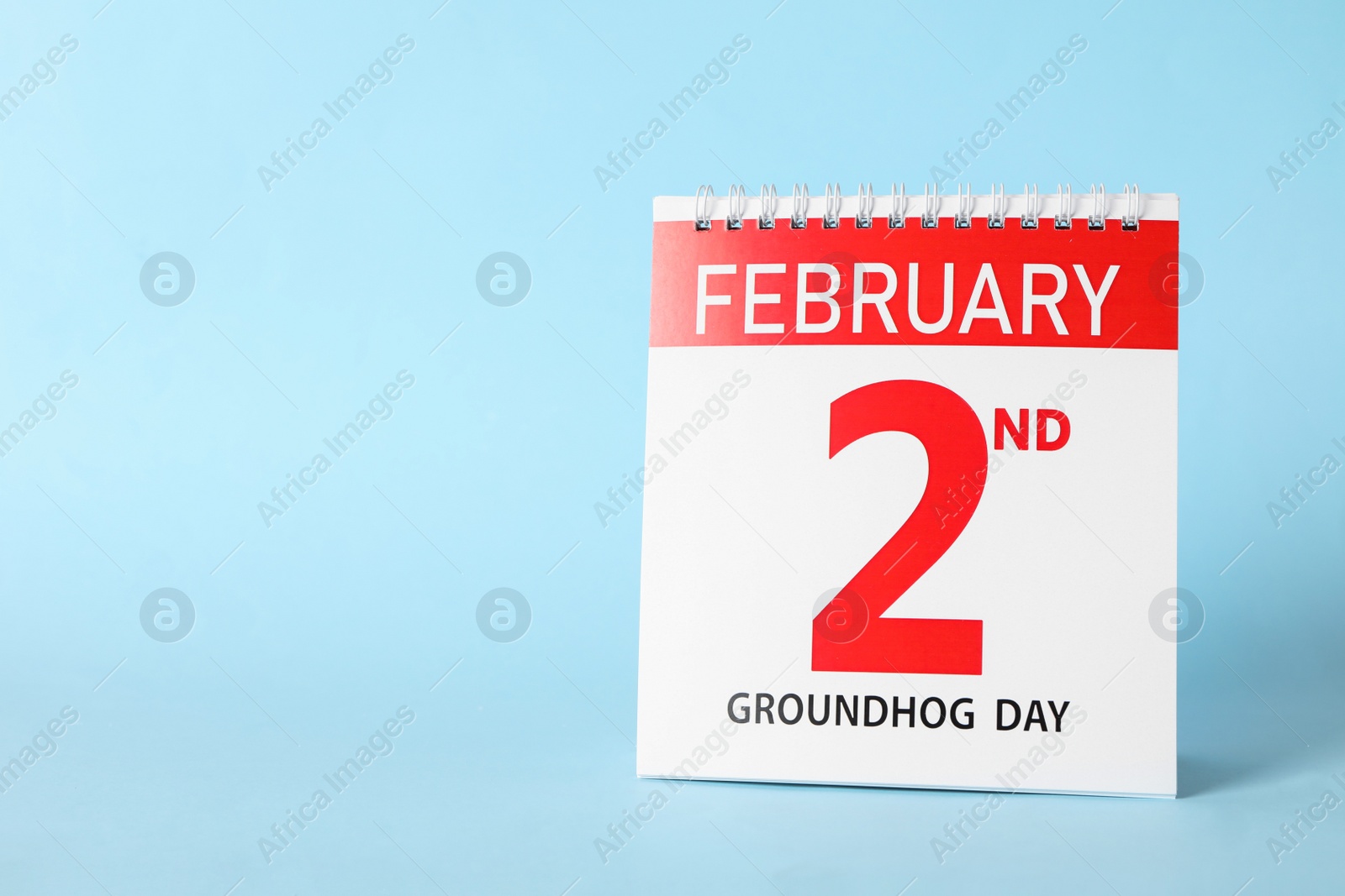 Calendar with date February 2nd on light blue background, space for text. Groundhog day Photo of Calendar with date February 2nd on light blue background, space for text. Groundhog day