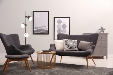 Stylish living room interior with comfortable furniture and pictures Photo of Stylish living room interior with comfortable furniture and pictures