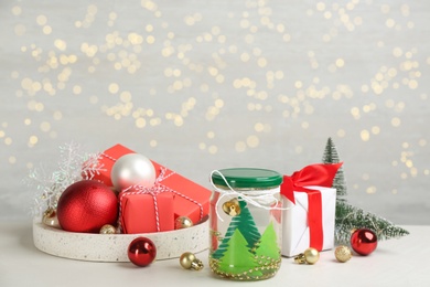 Handmade snow globe and Christmas decorations on light table, space for text Photo of Handmade snow globe and Christmas decorations on light table, space for text